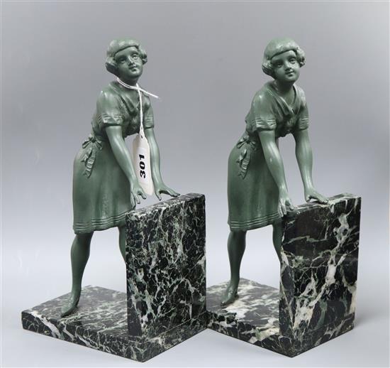 A pair of Art Deco green patinated spelter and marble figure bookends